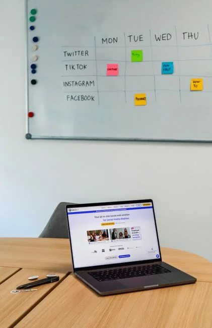 about-us Two businessmen analyze stock market data using a smartphone and laptop in a modern office setting.